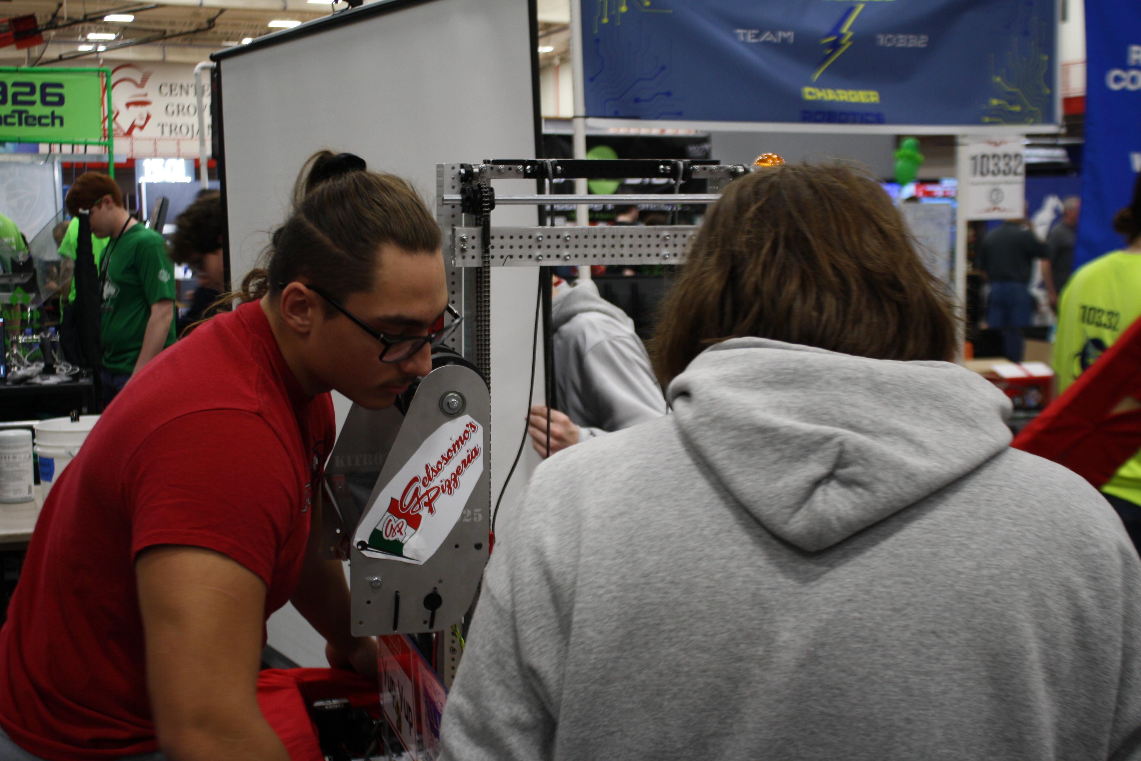 Two team members looking at the robot